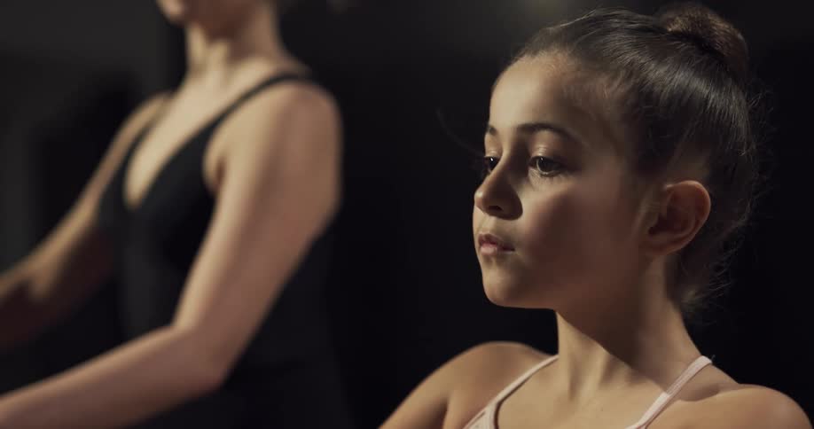A woman and child practicing ballet