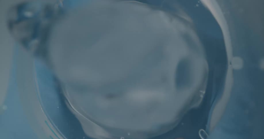 Blue white and gray colors that look like a jacuzzi jet underwater