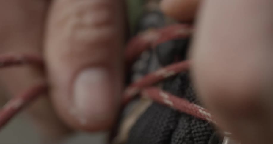 A person ties their boot laces