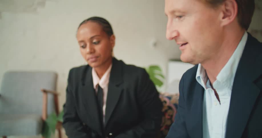 A man and woman talk in the office