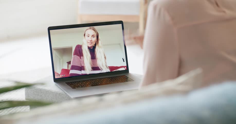 Two women talking over a video call using a laptop
