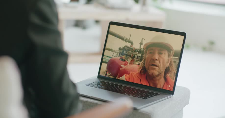 A man talking on a video call to another person in a construction site