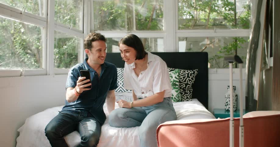 A man and woman talking on a phone with someone