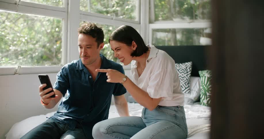 A man and woman looking at a cell phone