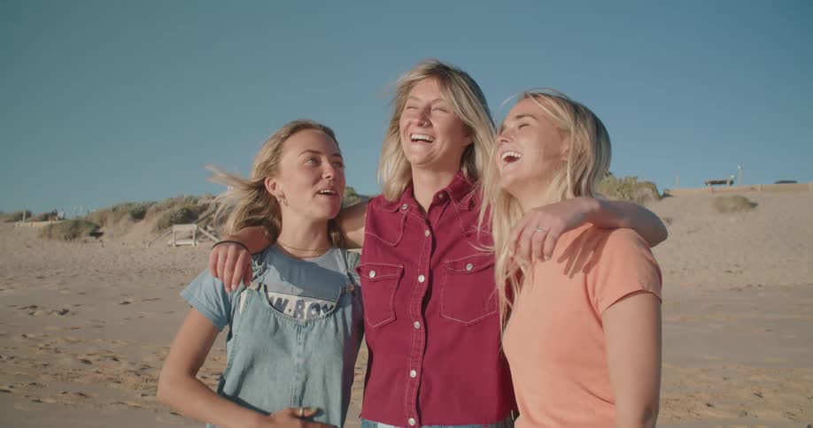 Teenage girls laugh on the beach