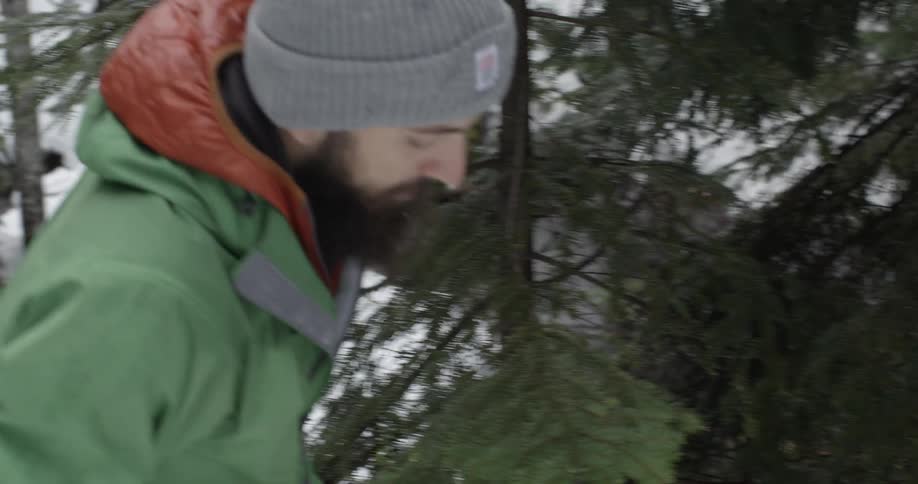 Bearded man turning around and walking the other way in a snowy wilderness