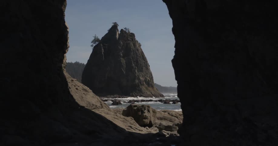 Looking from inside a cave to a beach outside
