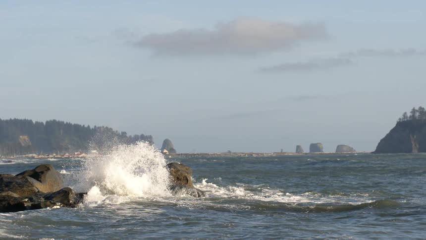 Ocean waves crash into rocks