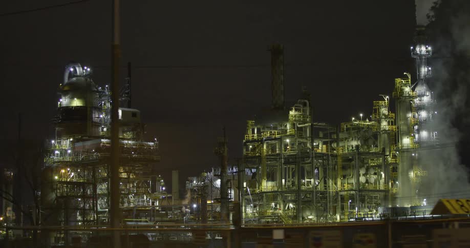Steam and vapor clouds rising from a power plant at nigth