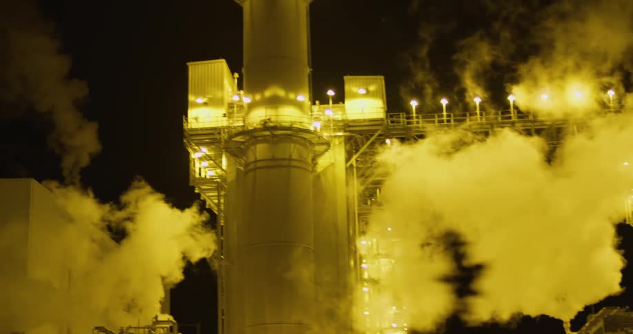 Smoke rising from a power plant at night