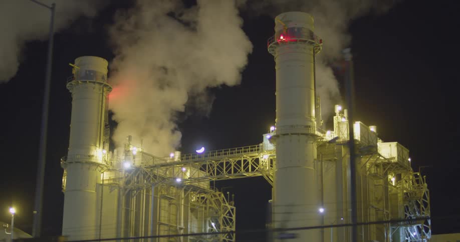 Pollution rising from a power plant with crescent moon in the sky