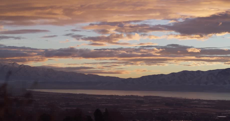Clouds floating above a mountain lake in nature at sunset