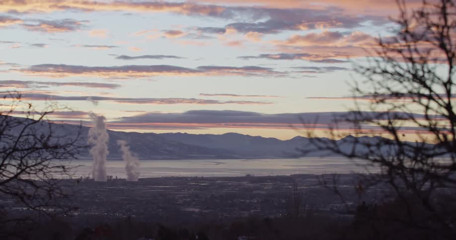 Smoke rising on the horizon at sunrise
