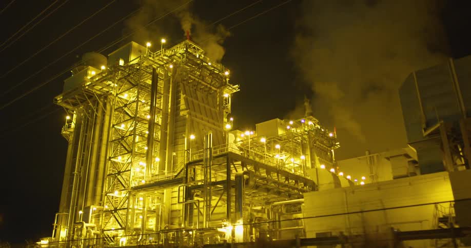 A refinery factory with smoke around it