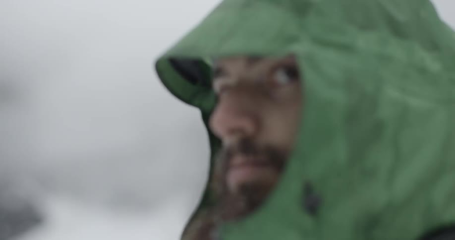 A man looking around at his snowy surroundings