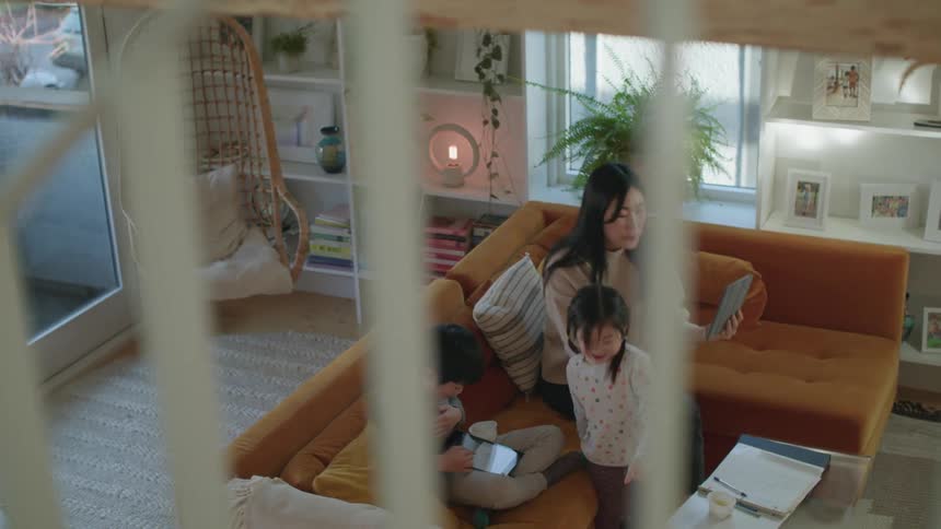 A young family sitting on a sofa in a living room