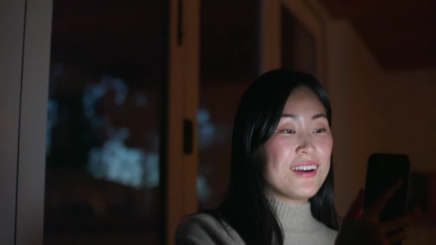 A woman talking to a smart phone