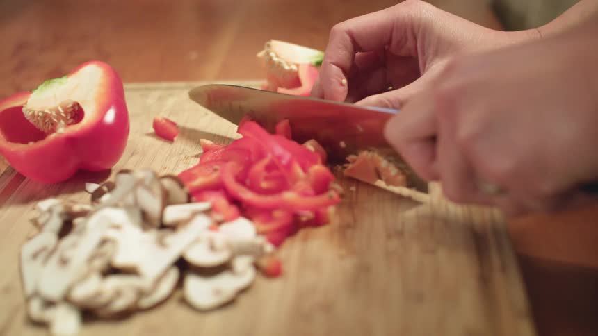 A man and woman in kitchen together preparing food