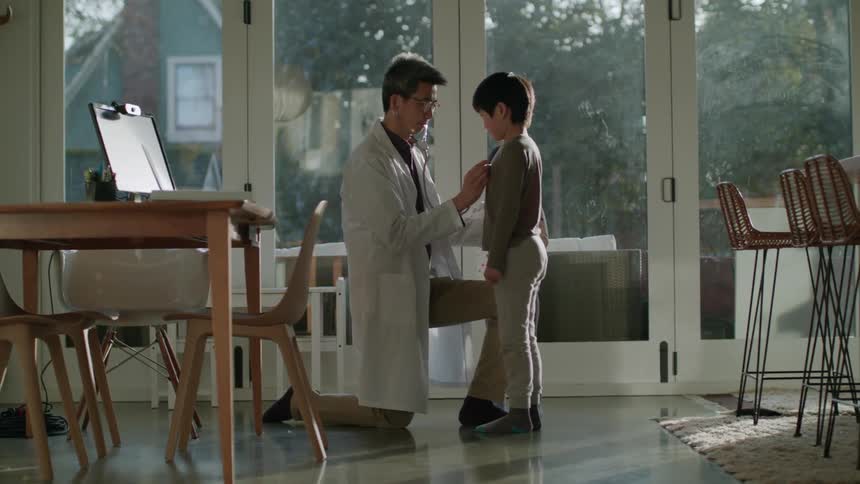 A doctor is using a stethoscope to check to children