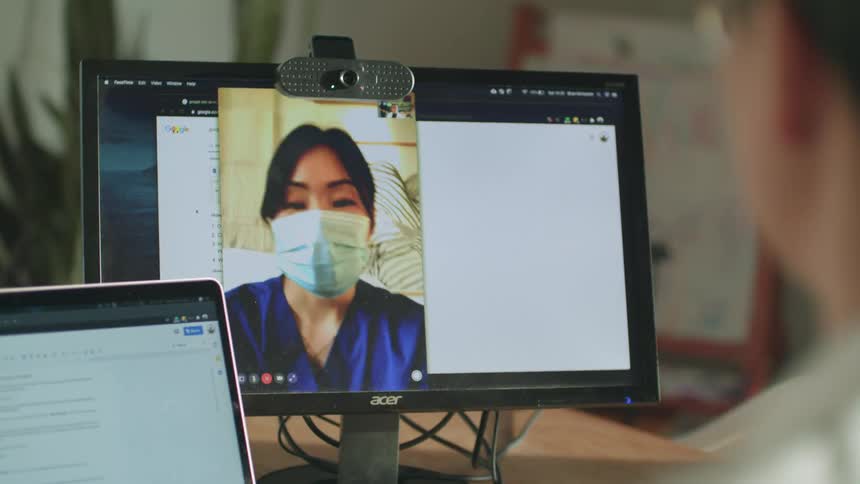 Two people talk on video conference