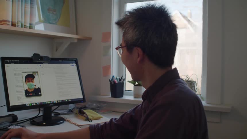 A man on a video call with another person