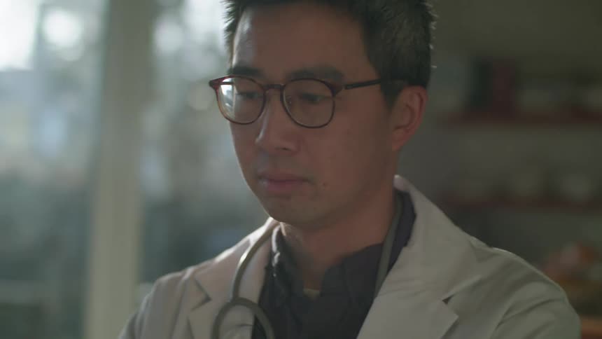 A doctor working on a laptop from his office at the hospital