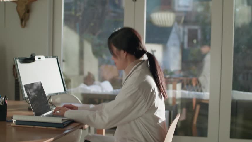 A woman sitting at a laptop