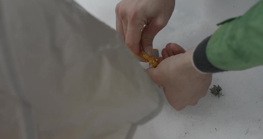 A tent is secured in the snow