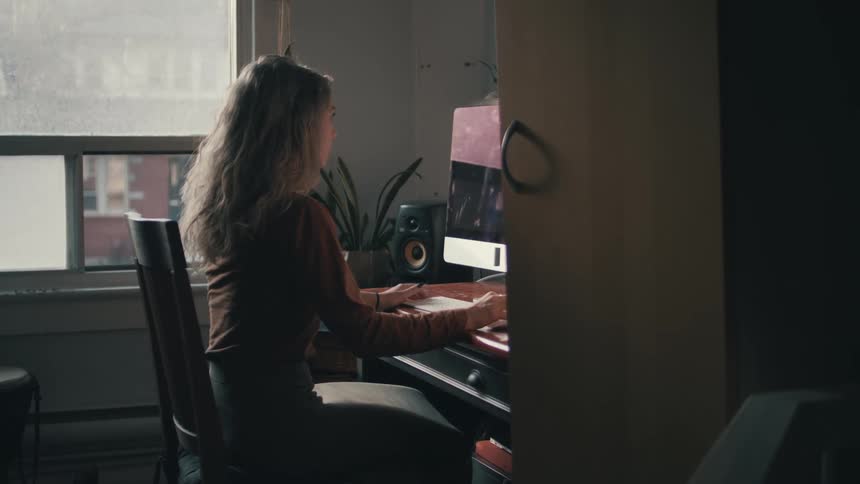 A woman is using the computer in the office