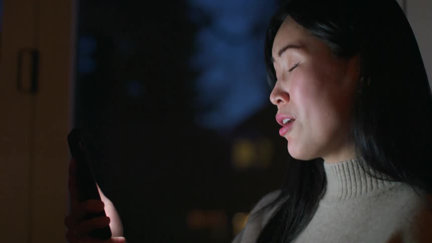 A woman standing outside talking on a phone