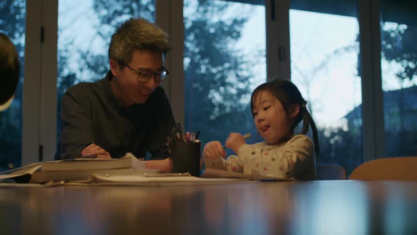 A father and daughter working on homework