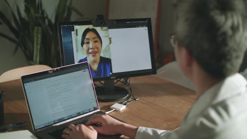 A man is working talking on a video conference