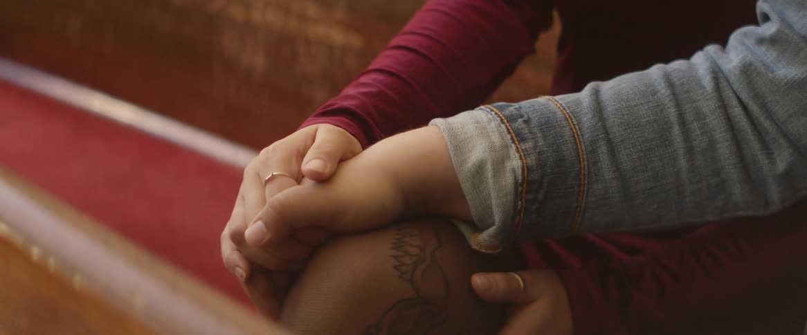 Two people lovingly holding hands