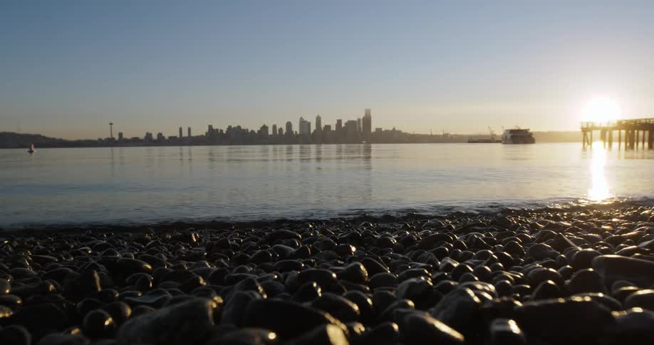 Ground level view of a shoreline with the sun setting
