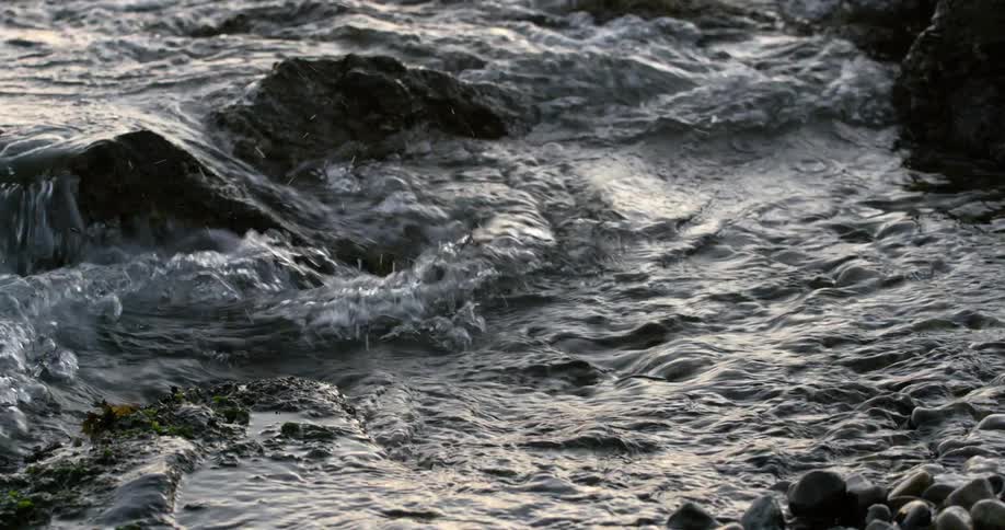 Water splashing up on the rocky shore