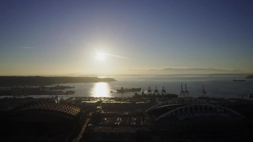 View of an industrial area at the water's edge at sunset