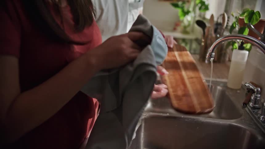 A man and woman doing dishes at home