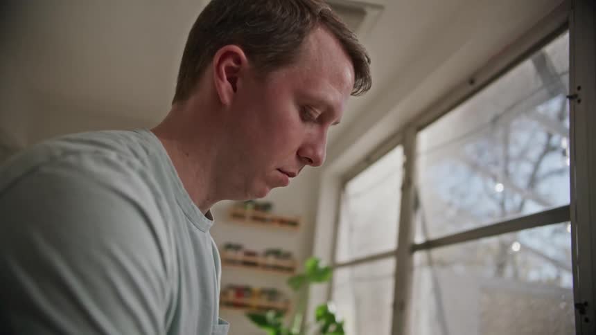 A man washing dishes in a kitchen