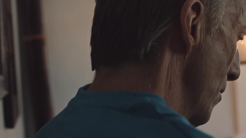 Close up of a man inside his home