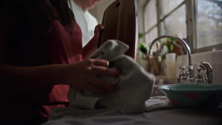 A man and woman are in the kitchen doing dishes together