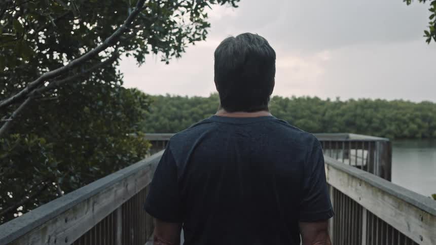 A man walks on to a dock
