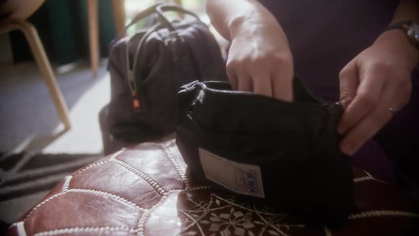 A doctor in a home takes a stethoscope out of a bag