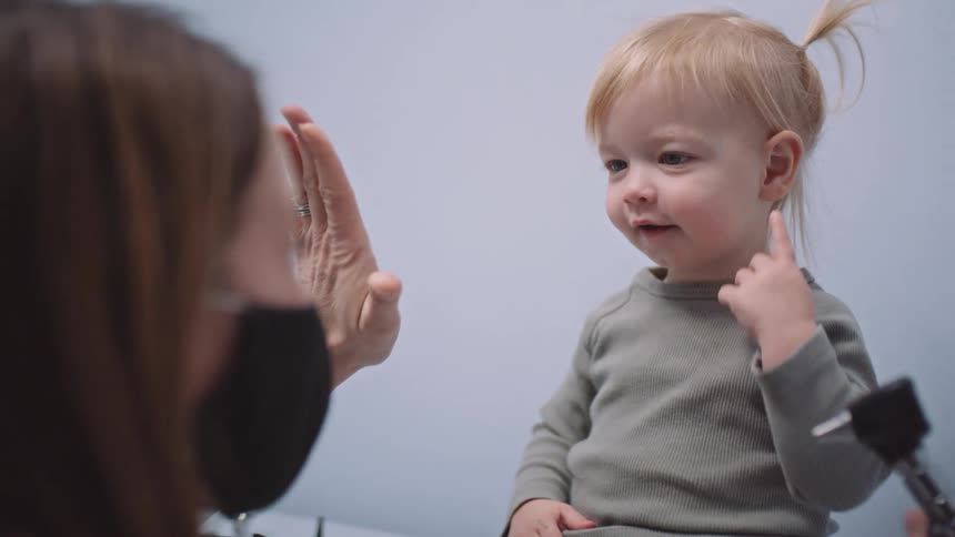 A toddler is in a doctors office getting a checkup