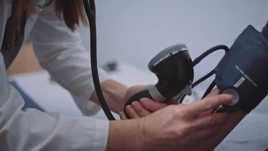 A doctor takes a patients blood pressure