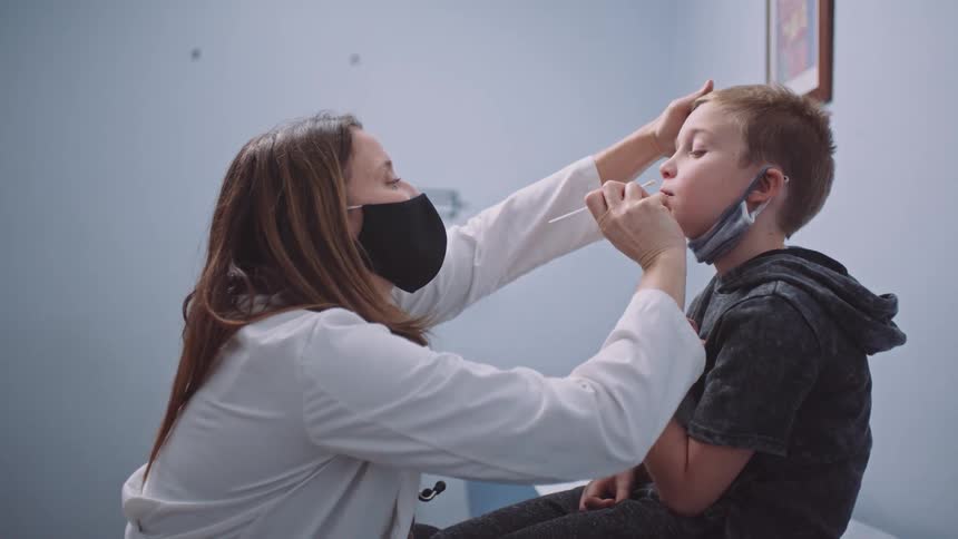 A child is sitting in a doctors office and getting tests done