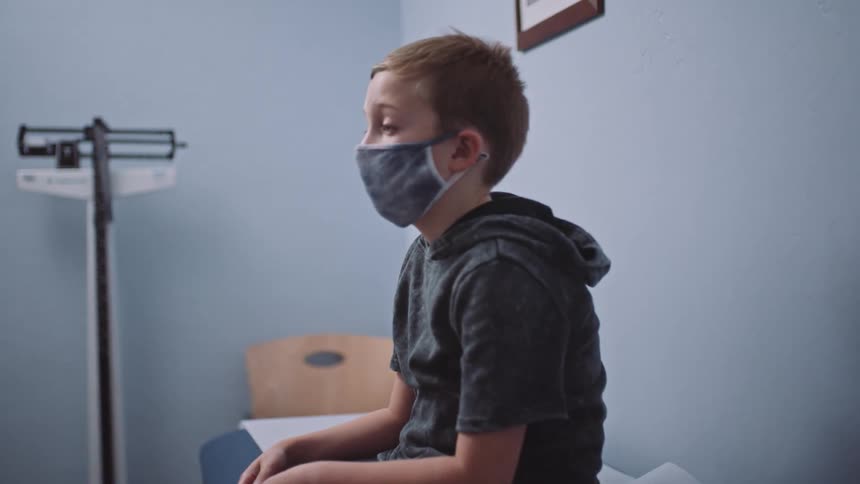A child is waiting in a doctors office during the day