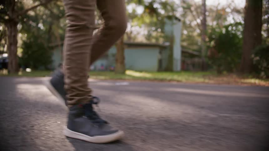 A person walking down a neighborhood street