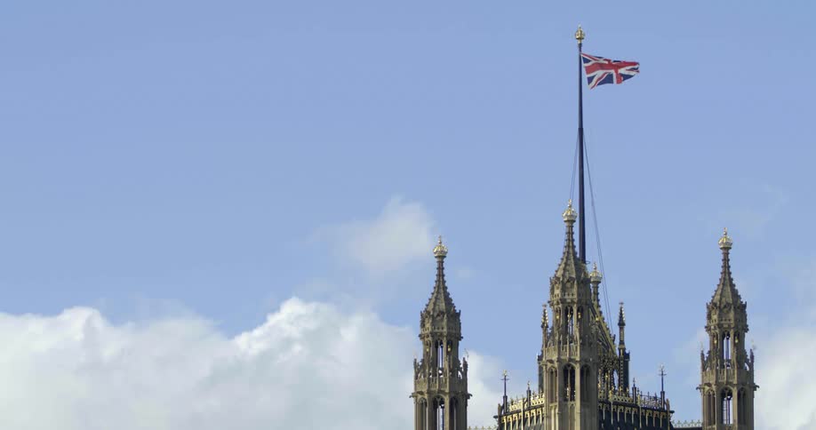 A flag waving on a pole on top of a tower