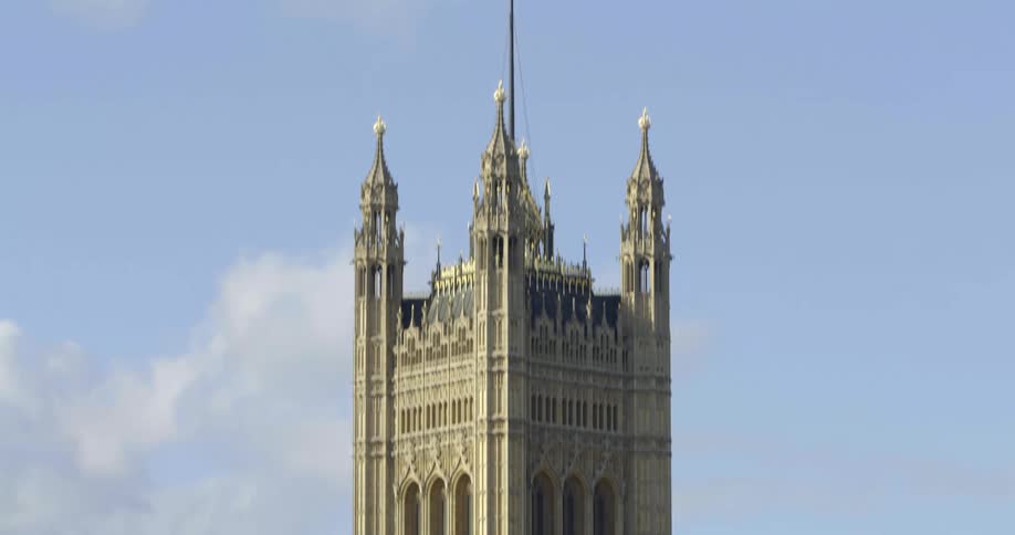 A tower with exceptional architecture stands tall next to a river in london