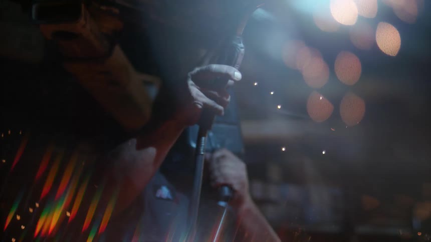 A man welds in slow motion